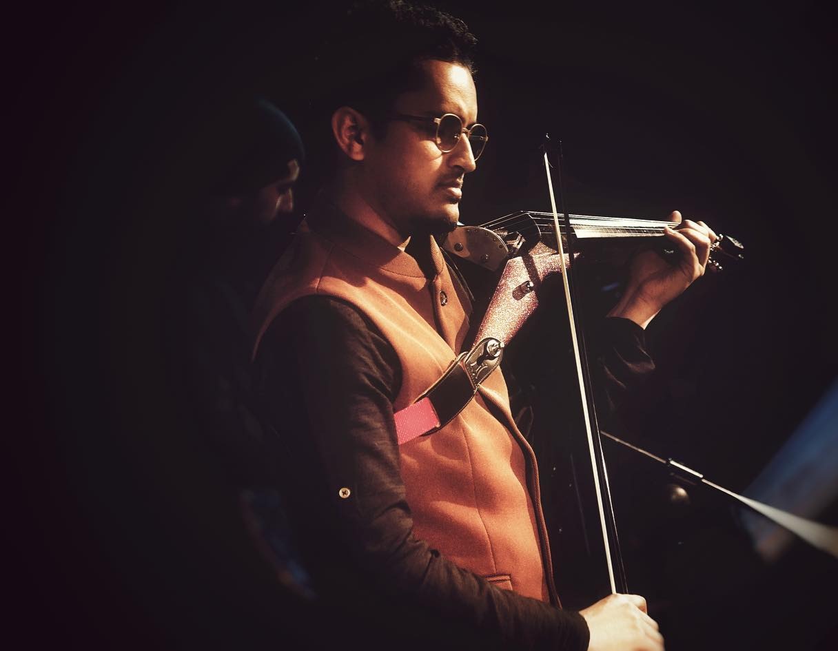 Rohan Roy performing violin